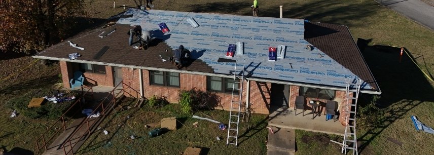 Crew laying new underlayment on a brick ranch home